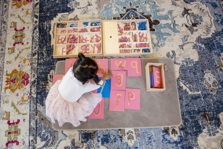Student playing with Montessori letters